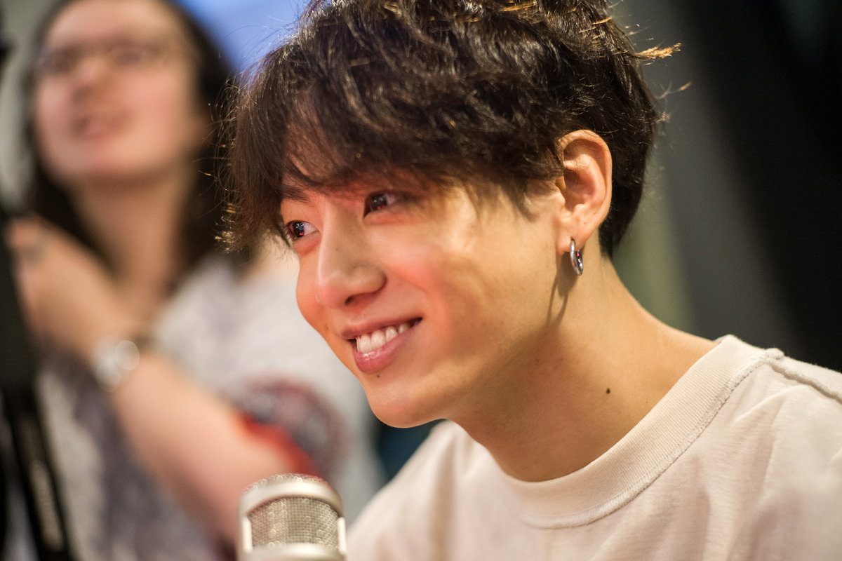 Jungkook smiles while visiting the Elvis Duran radio show in New York, NY.