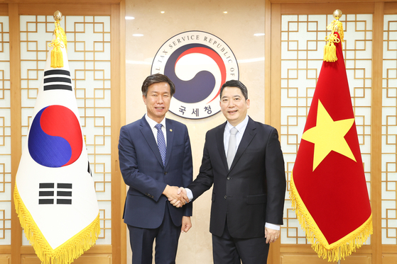 Korean National Tax Service Commissioner Kim Dae-ji, left, poses with Director General of the General Department of Taxation of Vietnam Cao Anh Tuan in Seoul on Monday. [NATIONAL TAX SERVICE]