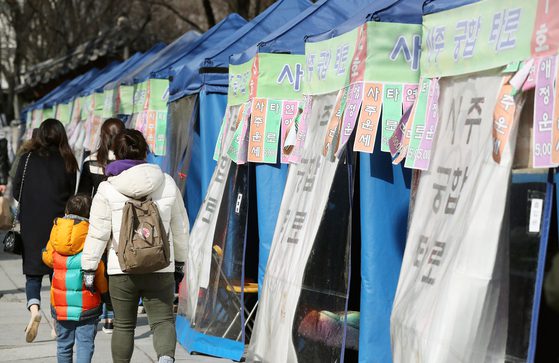 2017년 2월 24일 서울 종로구에 점쟁이들이 세운 천막을 사람들이 걷고 있다. [YONHAP]